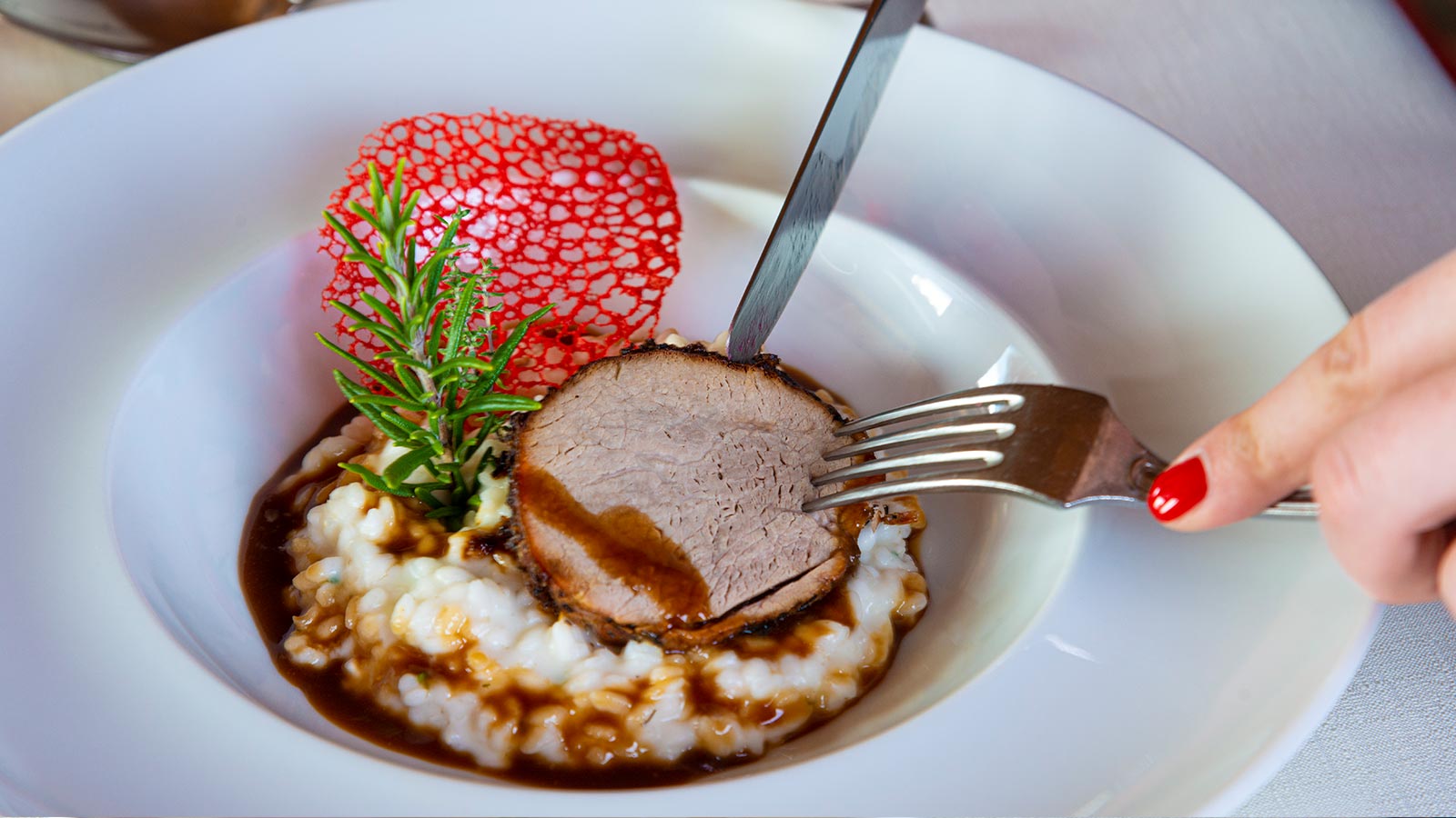 Detail eines Gerichtes mit Fleisch und Reis im Hotelrestaurant in Tiesens